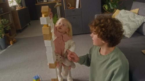 Brother and Sister Playing and Building Tall Tower