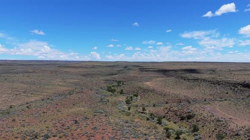 Flying Over Dry Riverbed in Arid Savanna of Namibia Africa Showcasing Immense Wild Natural Landscape