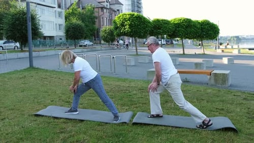 Sports Fitness Senior Elderly Sport Man Woman Training in Summer Park in the Morning