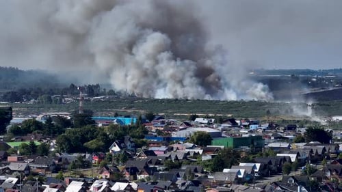 Aerial View Of Distant Forest Fires In Chilean City Of Puerto Montt With Large Plumes Of Smoke Risin