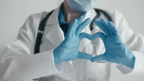 Health Care Provider Makes Heart Shape with Hands
