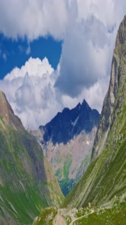 Vertical Video The Swiss Alps in Summer are an Incredible Natural Landscape with Clouds Hanging Over