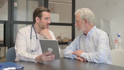 Doctor Consults with Senior Patient using Tablet Device