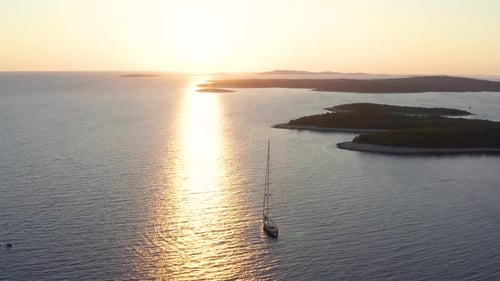 Sailboat Sailing In The Adriatic Sea With Beautiful Reflections Of Sunlight Reflecting On The Surfac