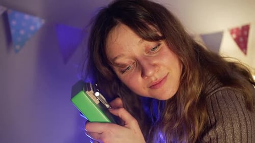 Green Kalimba Musician Performing with Closed Eyes Peaceful Expression Softening Amid Colorful