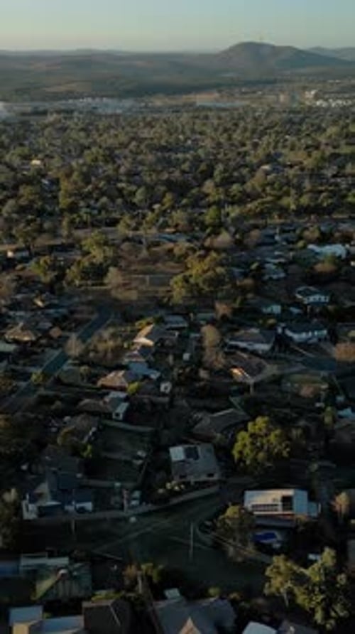Vertical drone housing Canberra suburbs Black Mountain Tower afternoon residential neighbourhood