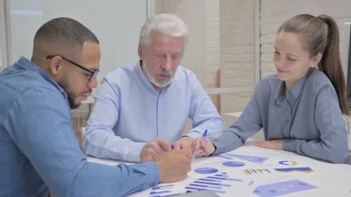 Teammates Working on Documents in Office