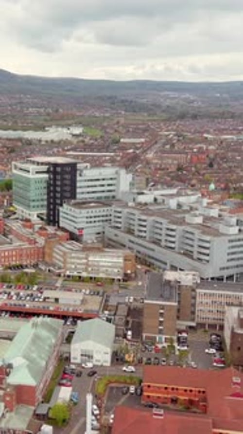 Wide rotating vertical social ratio 60FPS aerial video of Royal Victoria Hospital in Belfast