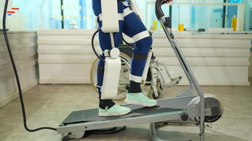 Person Walking on Treadmill with Robotic Exoskeleton