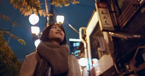 Night, walking and Japanese woman in city for exploring on vacation, adventure or holiday