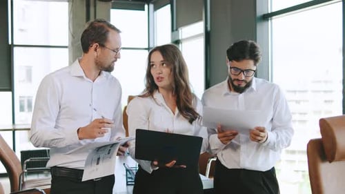 Team Discusses Project Updates During a Business Meeting in a Modern Office Environment with Large