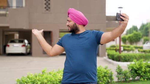 Man Vlogging Outside in Front of Apartment Building