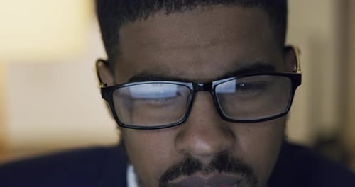 4k video footage of young businessman working online during a late night in a modern office