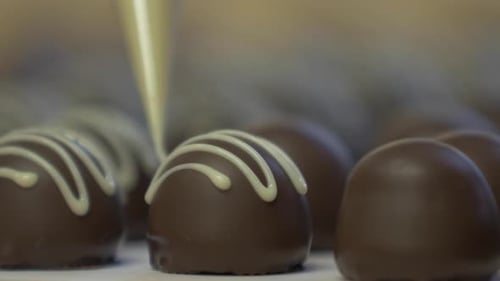 decorating chocolates with white garnish