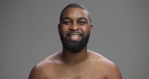 Studio, black man and face with smile for skincare, hygiene and model with confidence for wellness