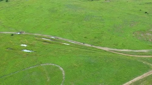 Motorcross riders riding by, high angle drone shot