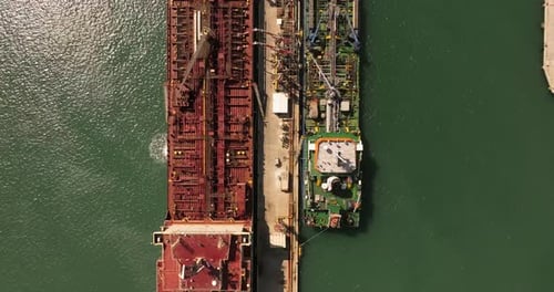 Oil tankers unloading crude oil in a port terminal.