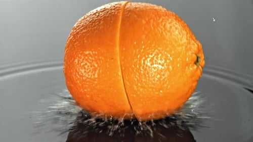 Orange Slices Fall on a Wet Surface Filmed on a Highspeed Camera at 1000 Fps