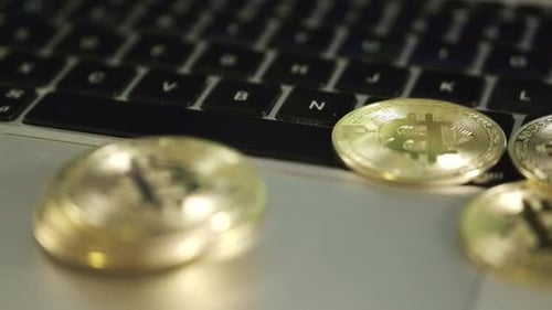 bitcoin golden coin on laptop keyboard rotating on line trading concept