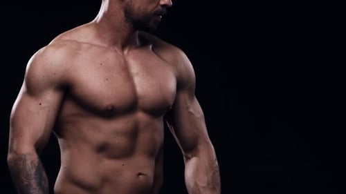 Fit and Sporty Bodybuilder Over Black Background Bodybuilder Training Using Barbell The Concept of