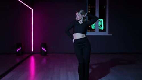 Live Camera Dancing Woman in a Choreographic Hall with Neon Illuminated Mirrors Expressive