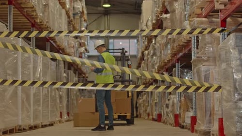 Worker Inspecting Warehouse