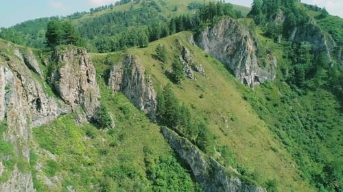 Aerial View of Green Mountain with Rocks Formations and Trees