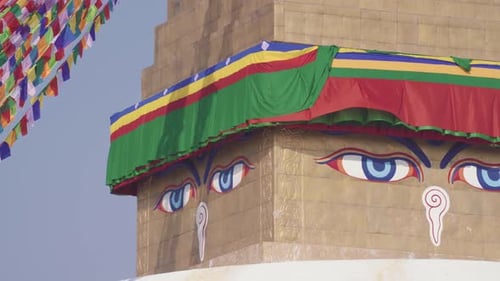 Detail Of Buddha Eyes With Prayer Flags At Boudhanath Stupa in Kathmandu, Nepal. - panning shot