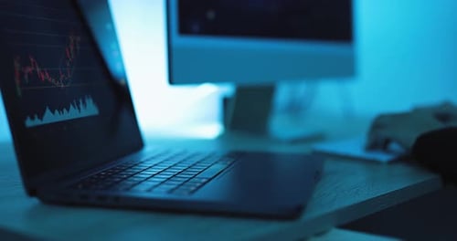 Laptop with Stock Chart in Cold Blue Lighting