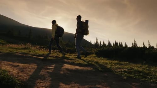 Two Climbers Climb Up the Mountain in the Sun Side View Concept Wins and Achievements