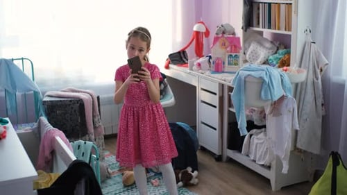 Girl Poses with Phone in Sunny Bedroom