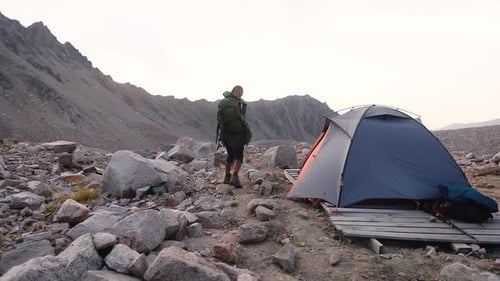 Hiker Arrives at Campsite in the Rocky Mountains