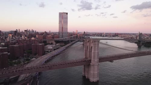 Aerial view of traffic on the Brooklyn bridge, sunset in NYC, USA - reverse, drone shot