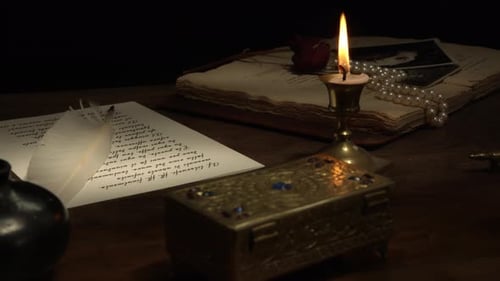 Candlelit Letter on Dark Wooden Desk