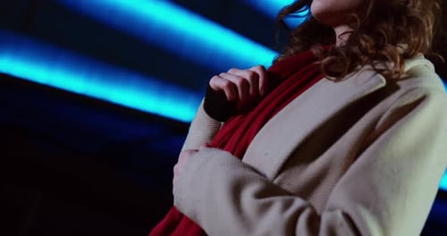 Woman Touching Red Scarf Under Blue Neon Lights, Winter Fashion Detail Close Up