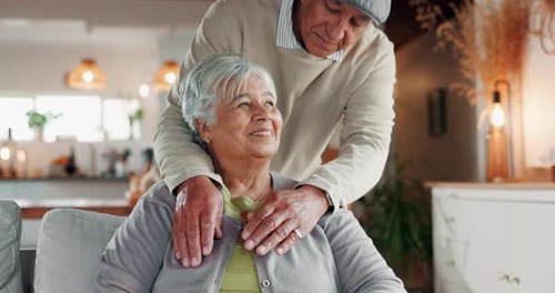 Loving Senior Couple Embrace and Kiss at Home