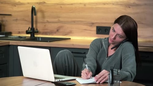 Woman Working from Home at Kitchen Table