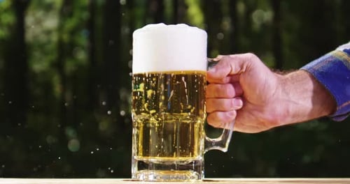Refreshing Beer Mug Outside with Bubbles and Foam