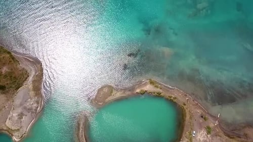 Aerial view of lake shore with beautiful turquoise water