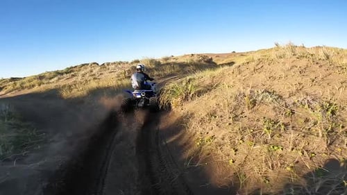 Man Riding An ATV in Sand Dunes. - POV shot