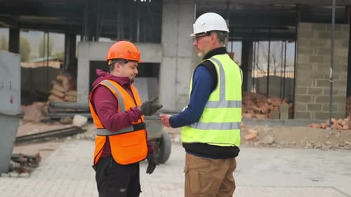 Supervisor, manager scolding employee for a mistake at construction site, dissatisfied quality work
