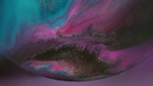 Colorful Liquids Swirling and Mixing with Shimmering Glitter