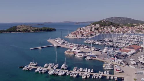 Aerial view of marina, boats, town, sea, and harbour in sunny Croatia.