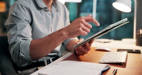 Man Using Tablet Computer at Desk in Office
