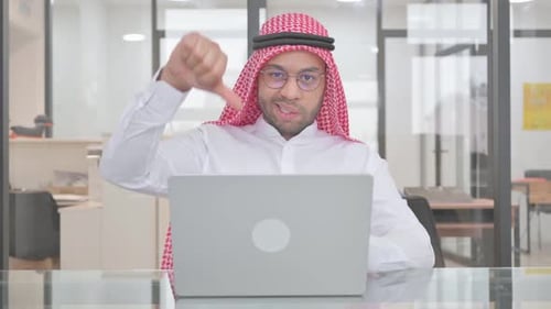 Thumbs Down by Young Muslim Man at Work