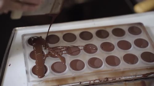 Pouring Melted Chocolate into a Plastic Mold