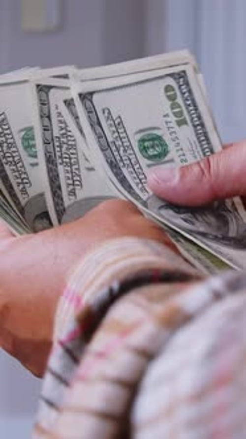 Counting Hundred Dollar Bills in Hands at Home