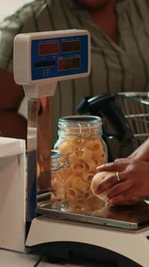Vertical Video Merchant Using Scale at Cash Register Checkout in Organic Shop