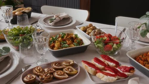 Laid table of salads and vegetables for dining