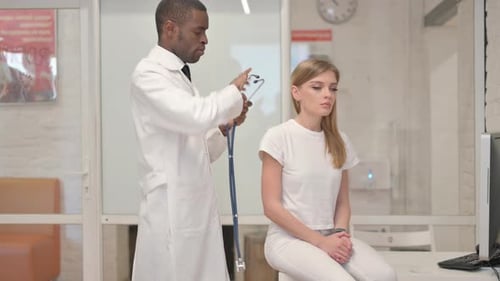 Doctor Examines Patient with Stethoscope in Clinic